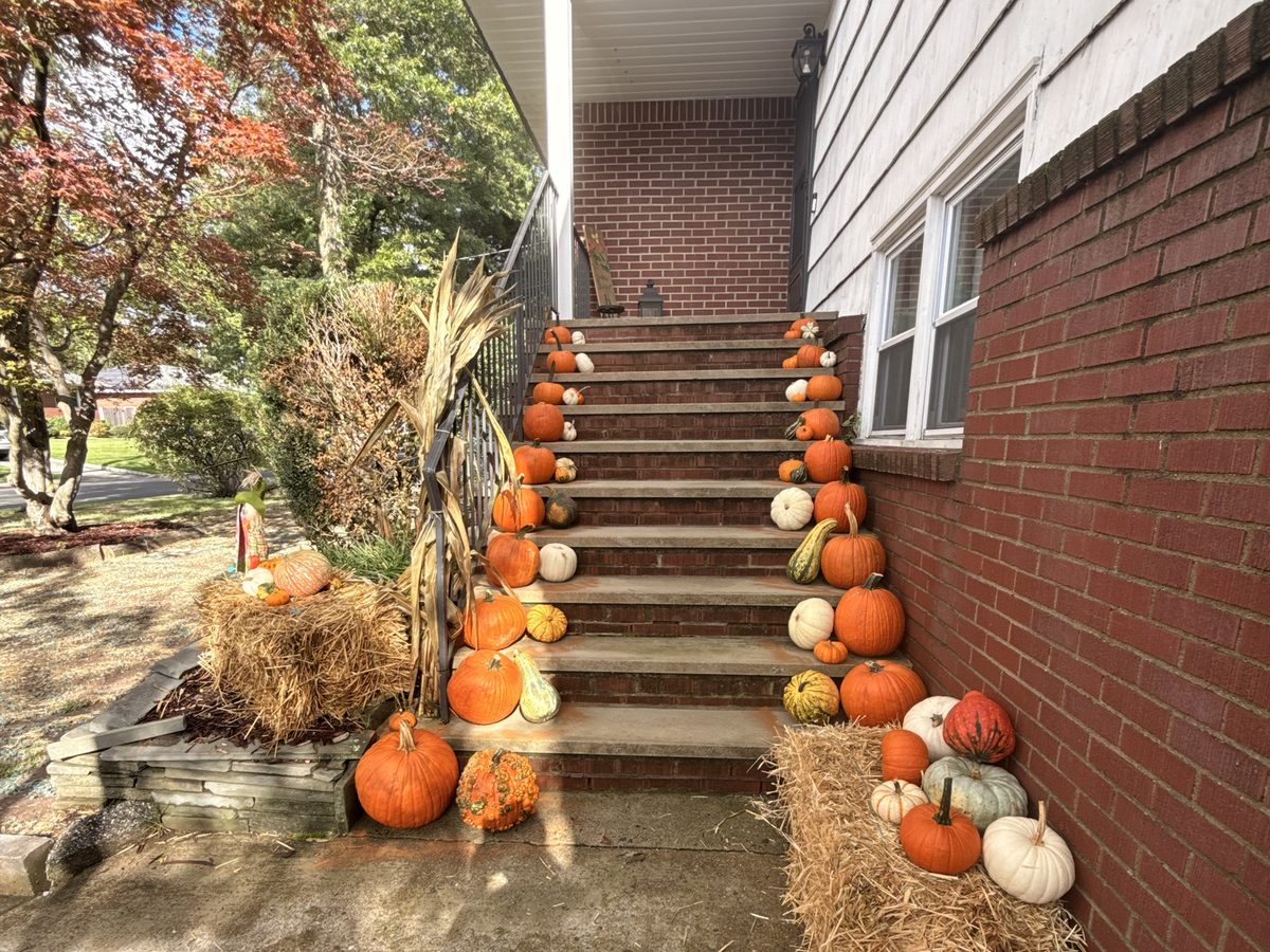 Pumpkin porch display on every step of a tall staircase in Hillsdale, NJ